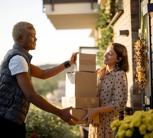 delivery-man-giving-parcels-to-caucasian-woman-2023-11-27-05-33-26-utc.jpg